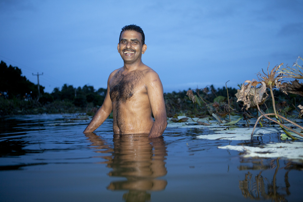 English teacher Nandasiri Wanninayaka takes a bath. Mahavilachchiya, Sri Lanka.